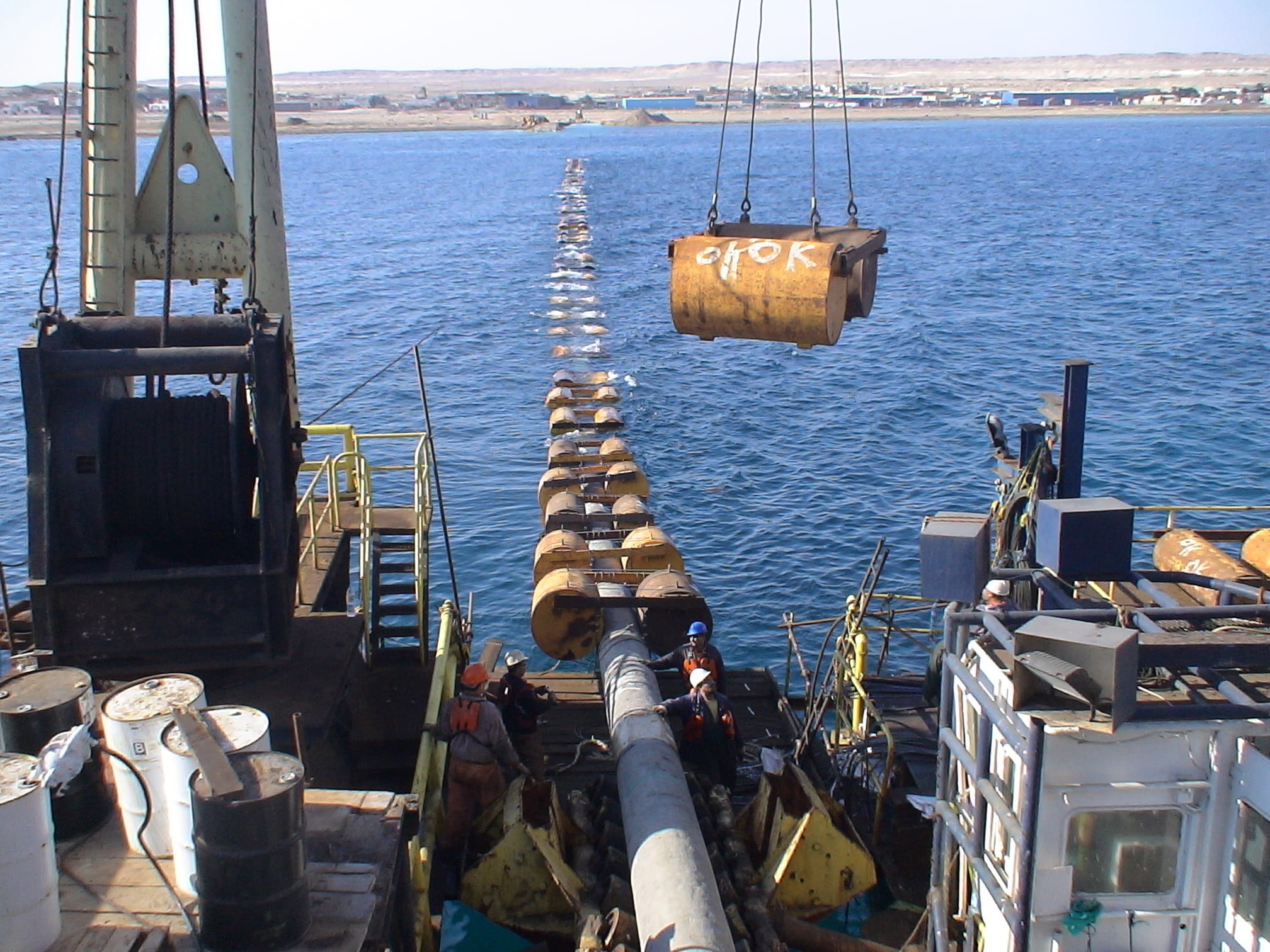 Pipeline strung on buoyancy floats during shore-pull works.