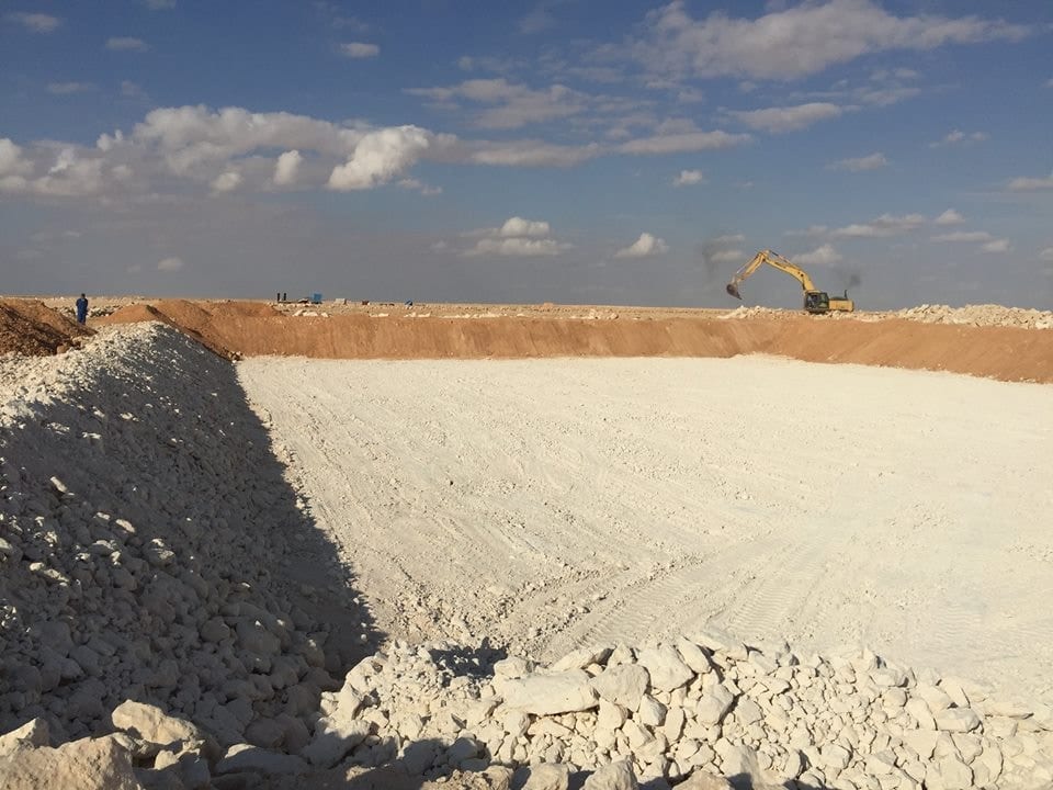 Excavating a pit at desert locations.