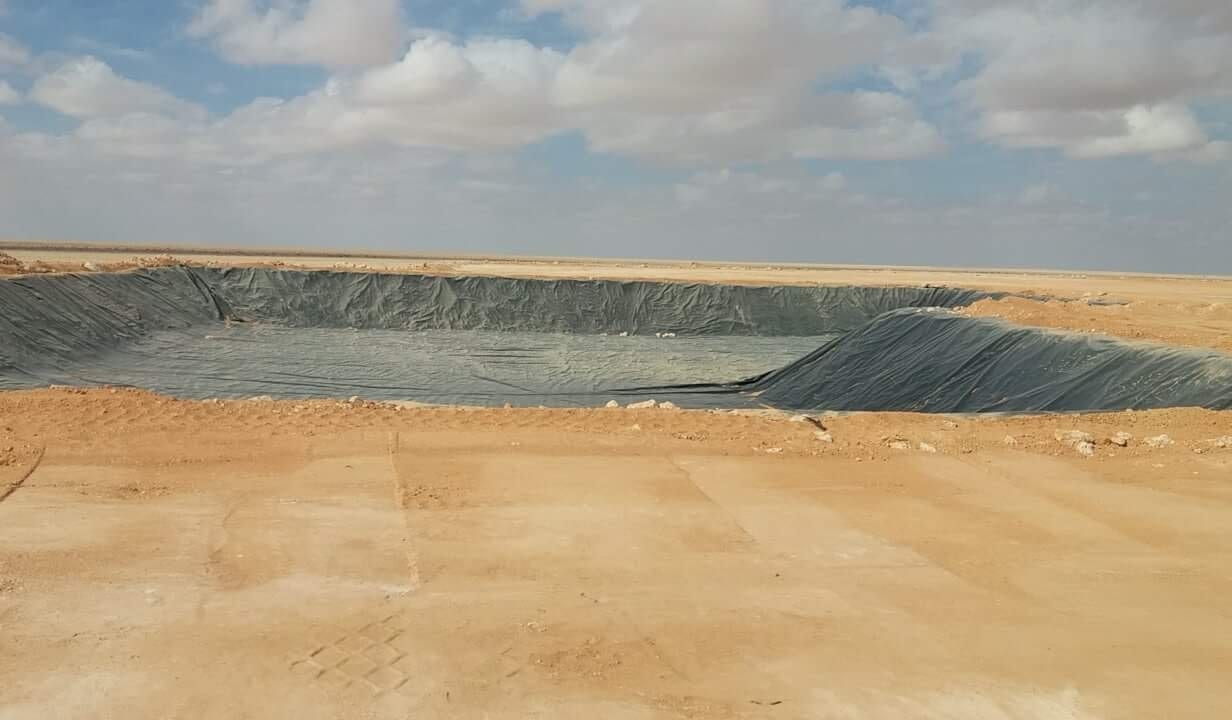 A pit with the plastic sheet installed.